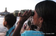 a lady uses binoculars to watch the sunrise in kanyakumari