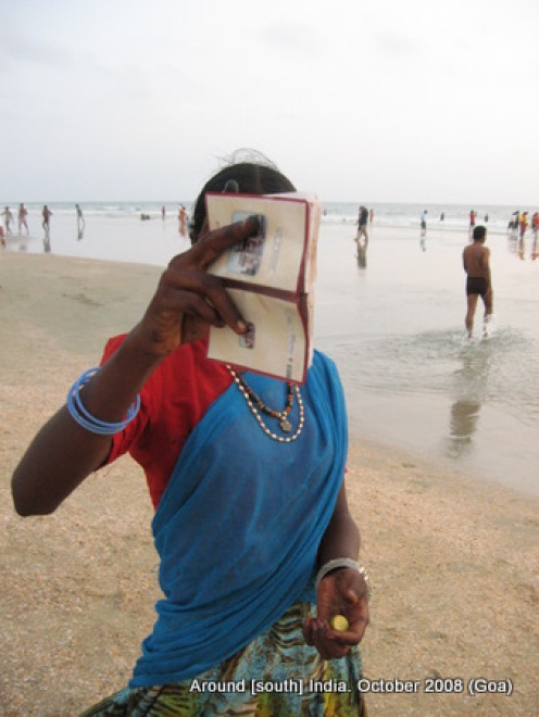 a woman painter at kolva beach hides her face from camera