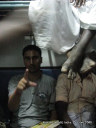 dangling legs of passengers in a train to madhurai from kanyakumari