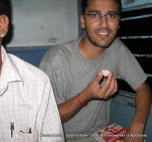 dinesh wagle eating laddu that his co-passengers offered to him