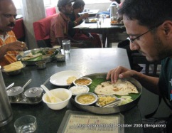 dinesh wagle eats food served on banana leaf and plate in a restaurant in bangalore