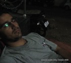 dinesh wagle struggles to take a nap on the street just outside a hotel in rameswaram