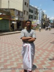 dinesh wagle wearing part of a dhoti in front of madhurai meenaxi temple