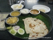 food served on banana leaf and a plate in a restaurant in bangalore