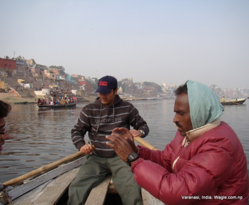 The boatman let us row as he chewed tobaco and took rest