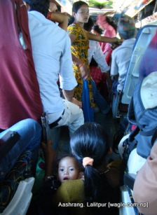A mother sits on the floor of the bus as she didn't get a seat for a few minutes.